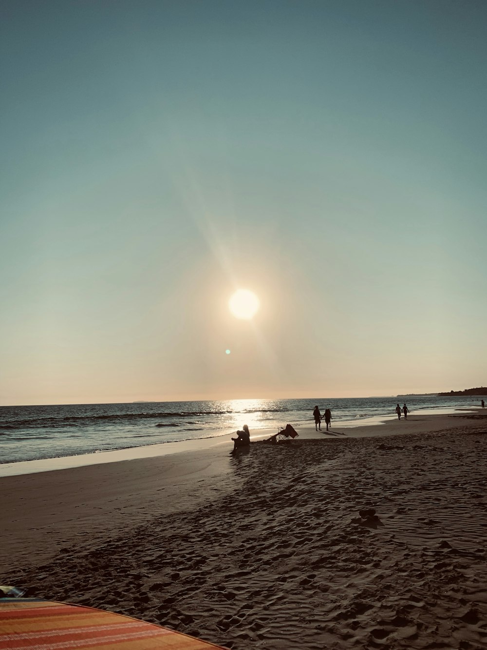 people on beach during sunset