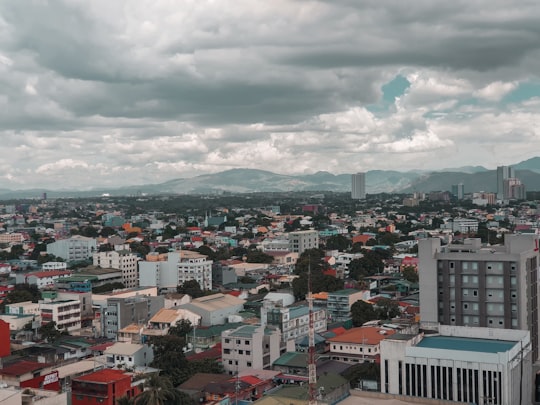 aerial view of city buildings under cloudy sky during daytime in Quezon City Philippines