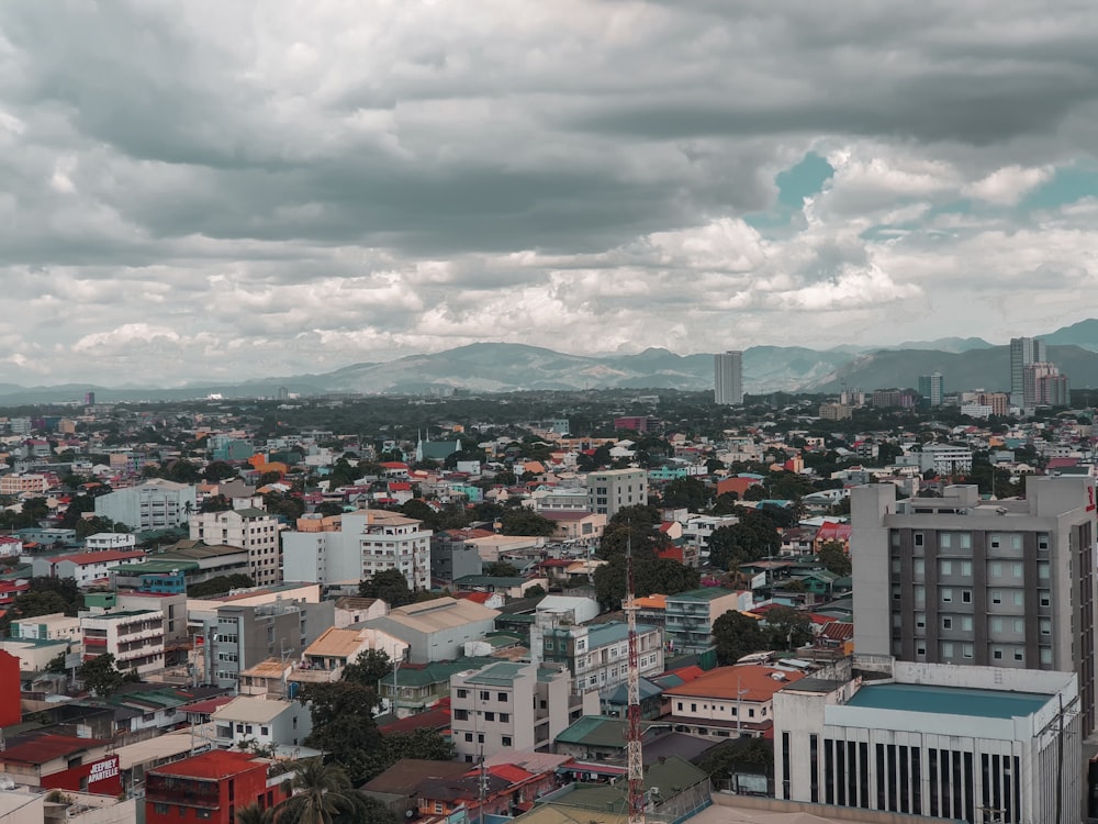 aerial view of city buildings under cloudy sky during daytime