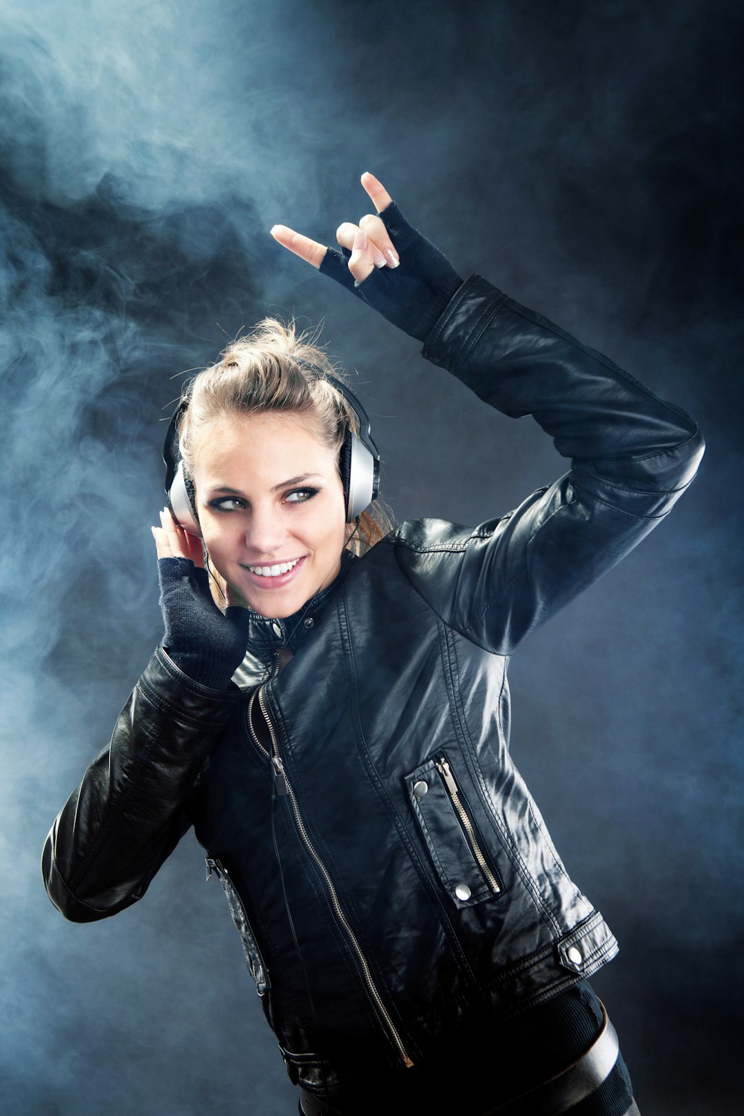 woman in black leather jacket holding red and white cigarette stick