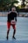 man in black and red nike jersey shirt holding white and brown basketball