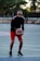 man in black and red nike jersey shirt holding white and brown basketball