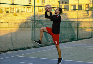 Close-up of a basketball player wearing knee pads and wrist supports in action on the court