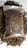 A clear plastic bag filled with dried, shredded brown material, possibly tobacco or a similar substance, rests on a surface. Loose pieces of the material are scattered around the bag.