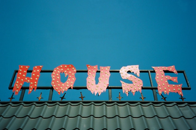 A vibrant sign showcasing a real estate property with clear branding.