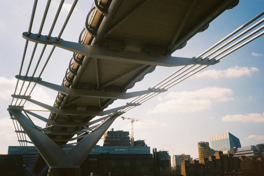 white metal bridge over the city during daytime