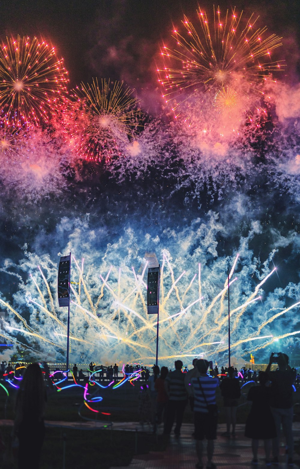 people watching fireworks display during nighttime