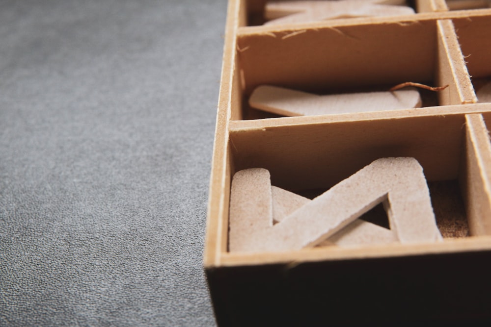 brown wooden box on gray carpet