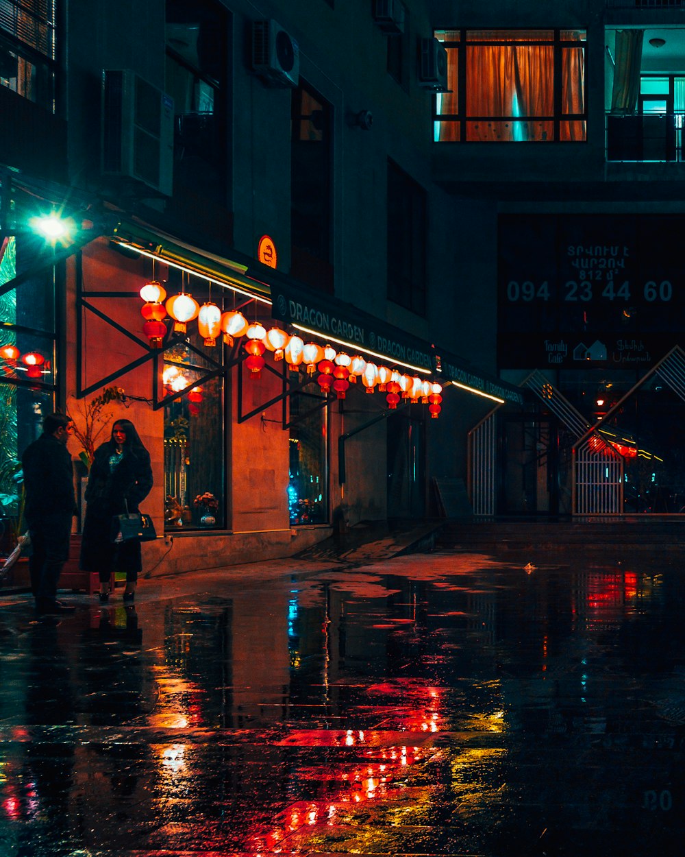 people walking on street during night time