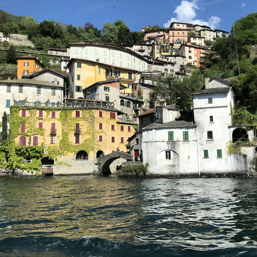 white and brown concrete building beside river during daytime