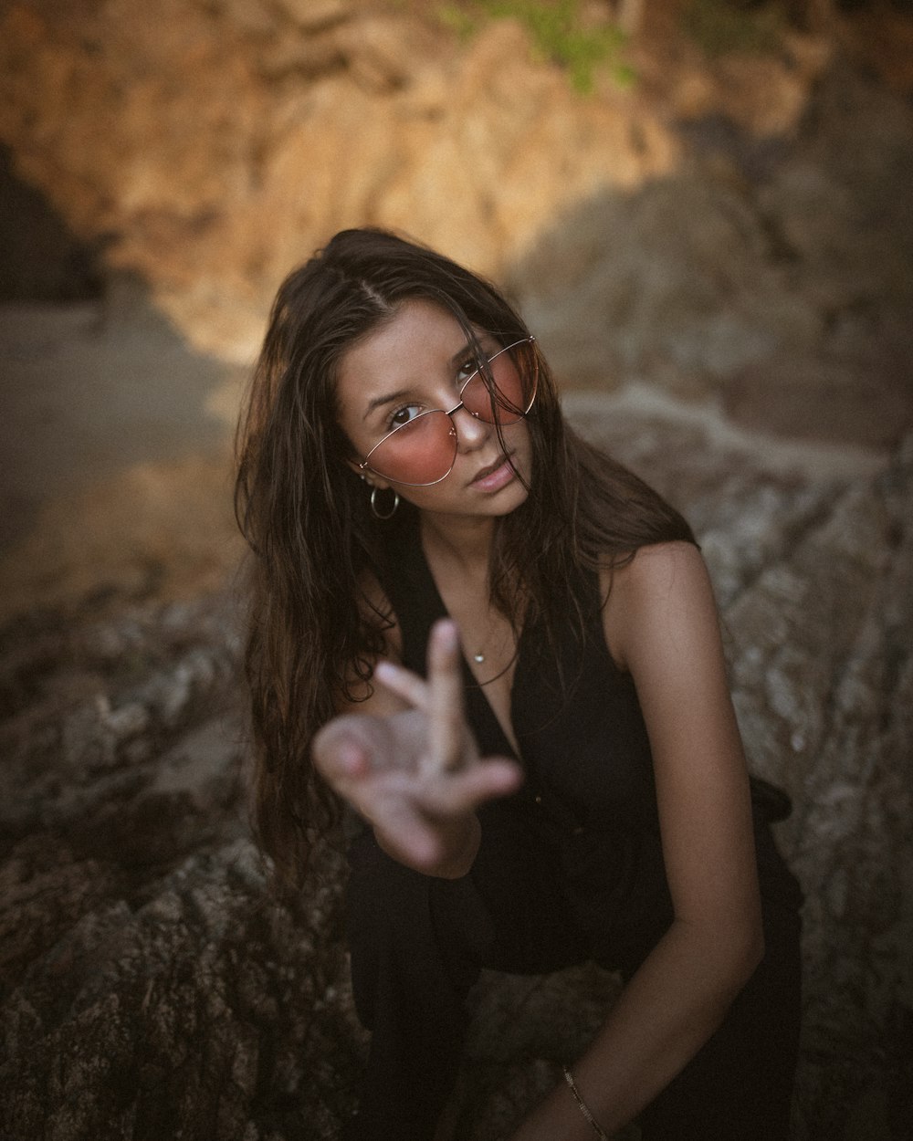 woman in black tank top wearing black framed eyeglasses