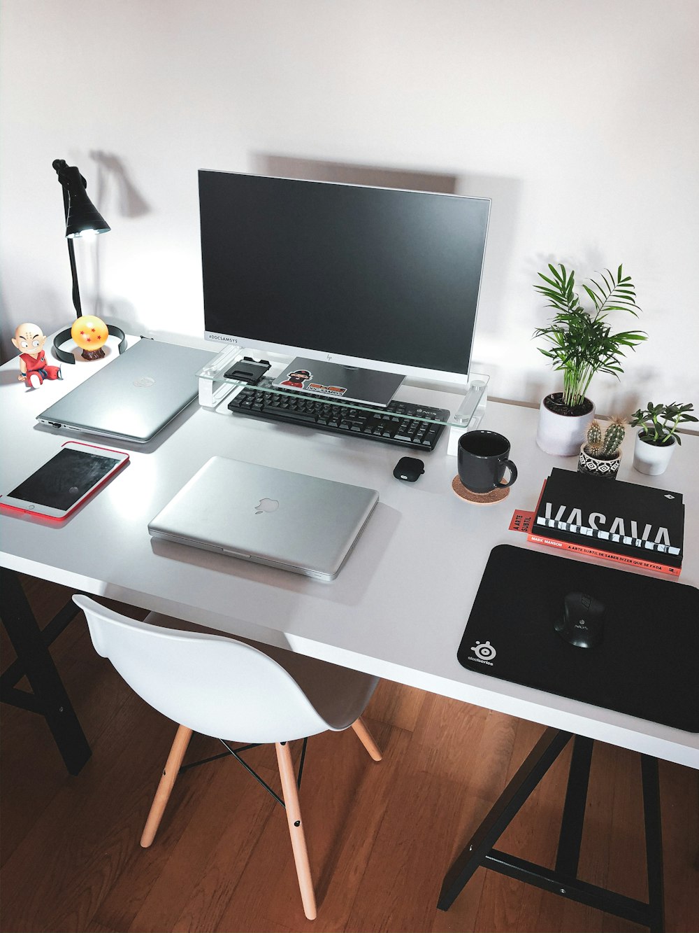 silver macbook pro on white table