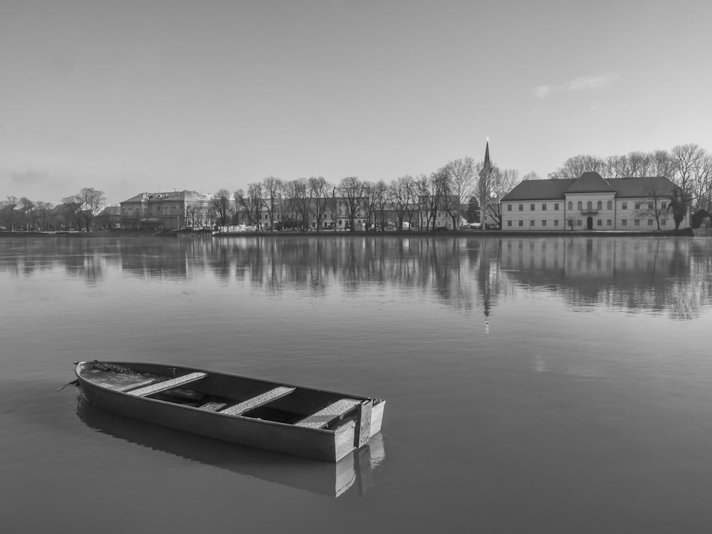 grayscale photo of boat on lake