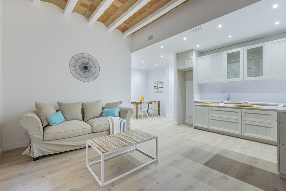 white and brown sofa near white wall