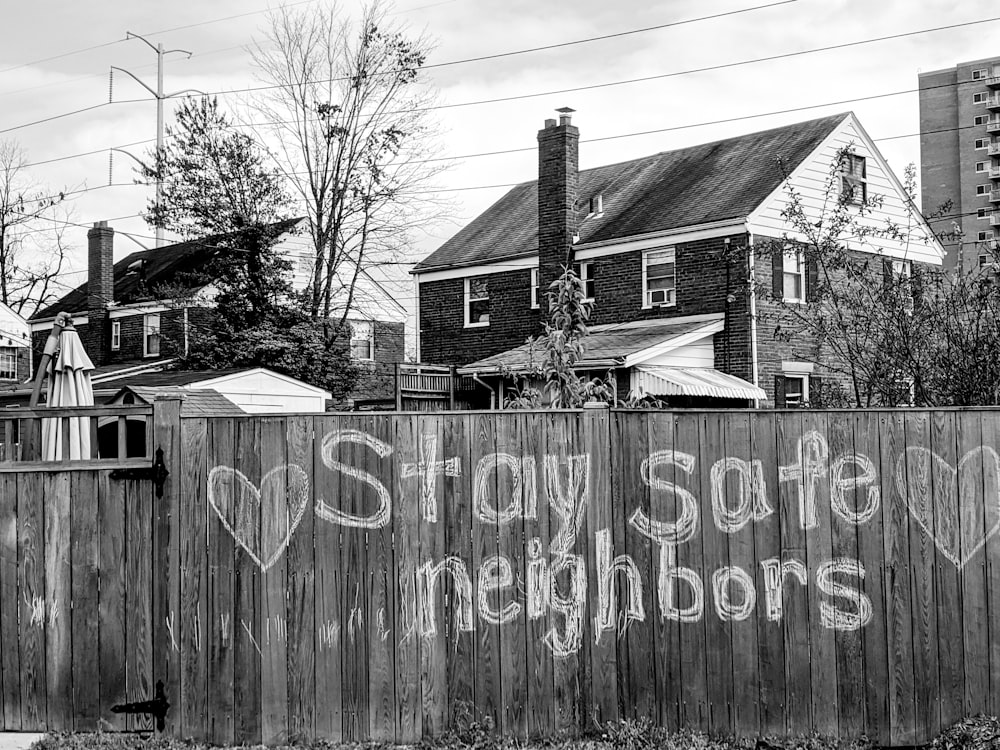 grayscale photo of wooden fence