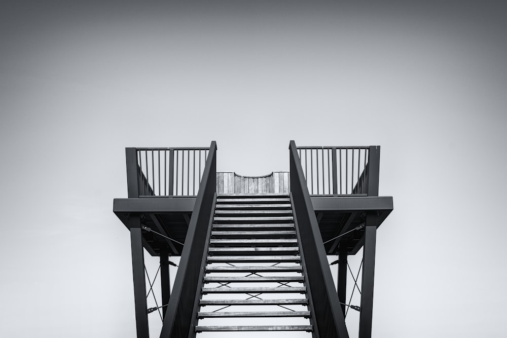 black wooden stairs under white sky