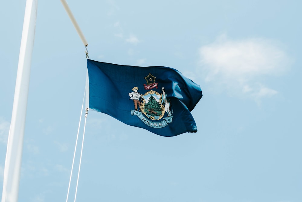 blue and white flag under blue sky during daytime