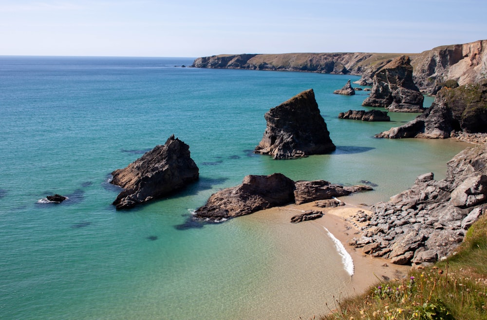 brown rock formation on blue sea water during daytime