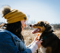 A mother and her pet wearing matching crochet accessories outdoors.