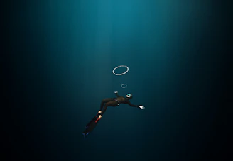 Instructor guiding a student through advanced diving techniques underwater.