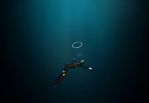 Instructor guiding a student through advanced diving techniques underwater.