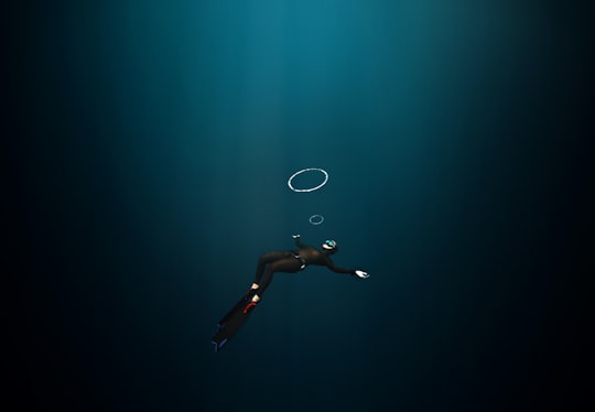 woman in black bikini bottom floating on water in Batangas Philippines
