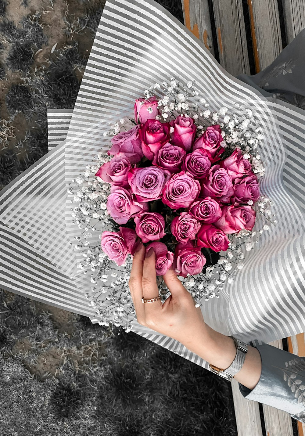 person holding bouquet of pink roses