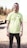 man in green crew neck t-shirt and black pants