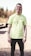 man in green crew neck t-shirt and black pants