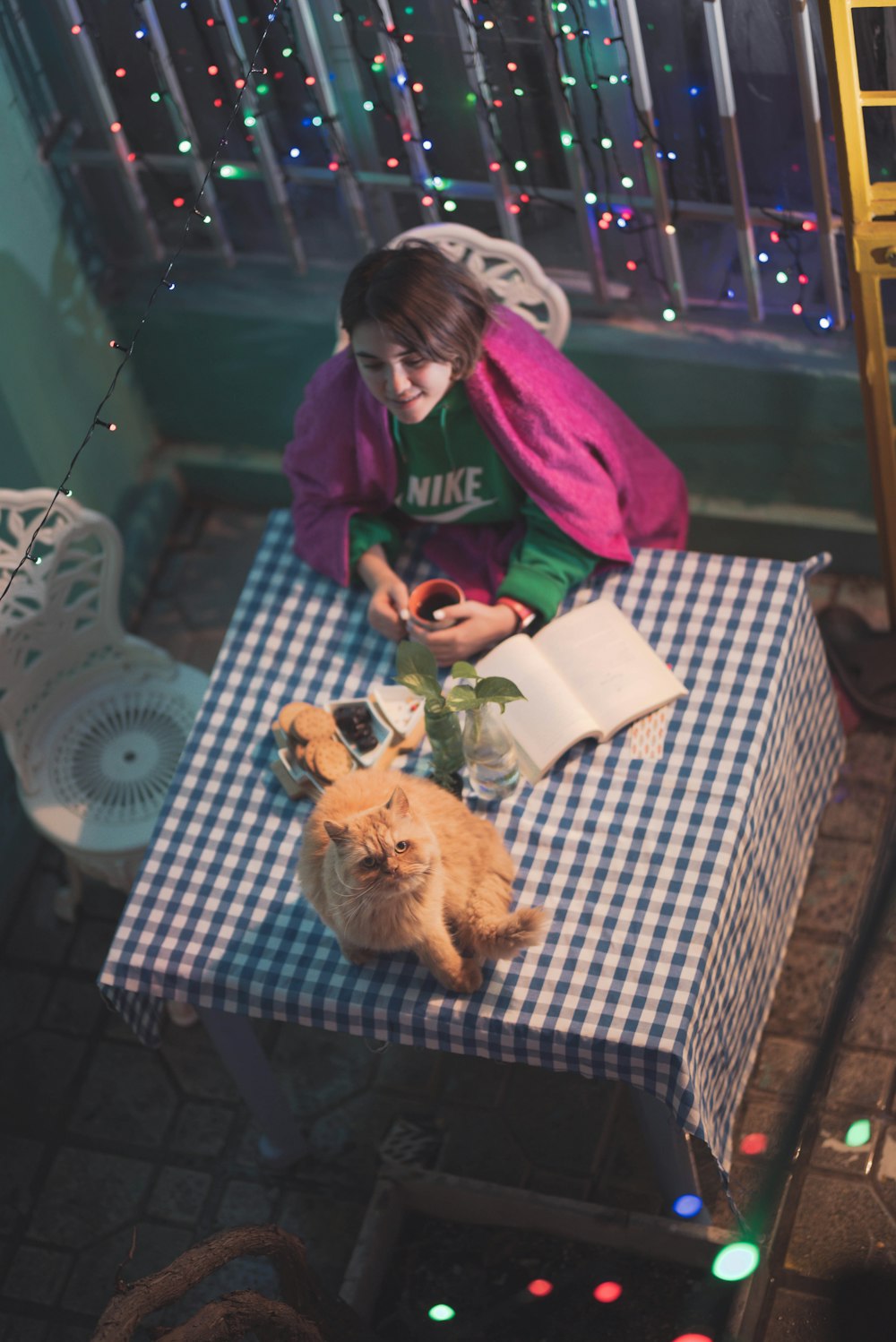 woman in green jacket holding brown bear plush toy