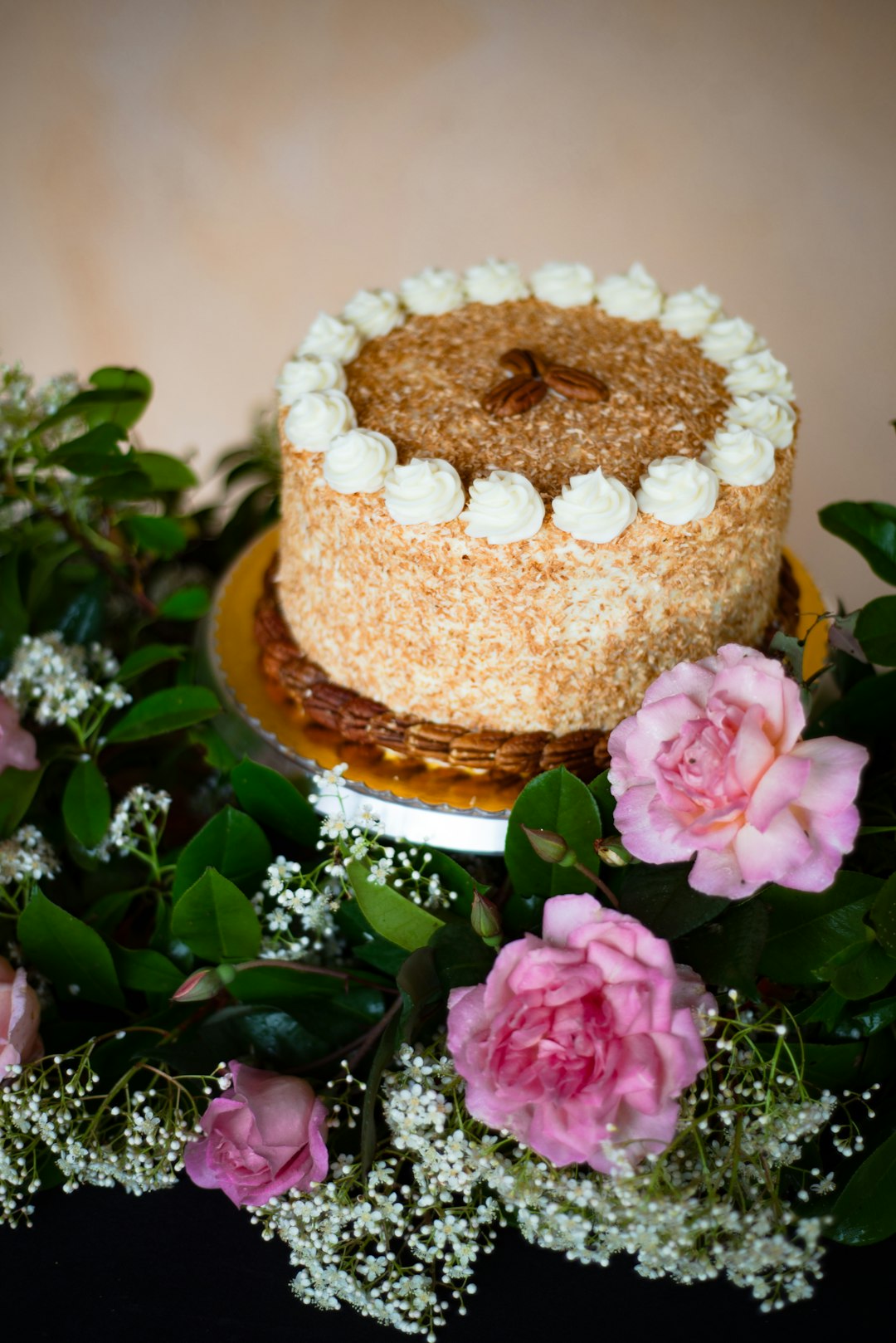 brown cake with pink flower on top