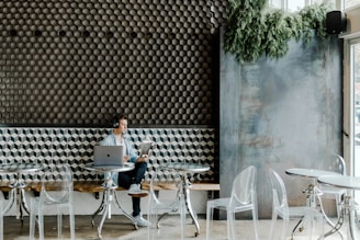 woman in black shirt sitting on white chair