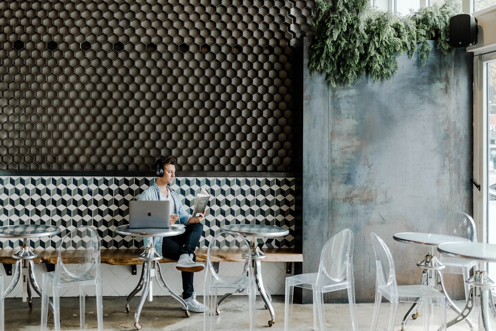 woman in black shirt sitting on white chair