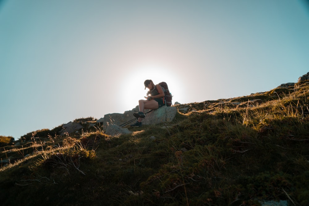 man and woman sitting on brown rock during daytime