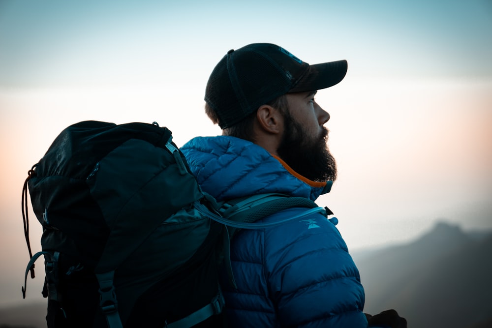 man in blue and black jacket and black cap