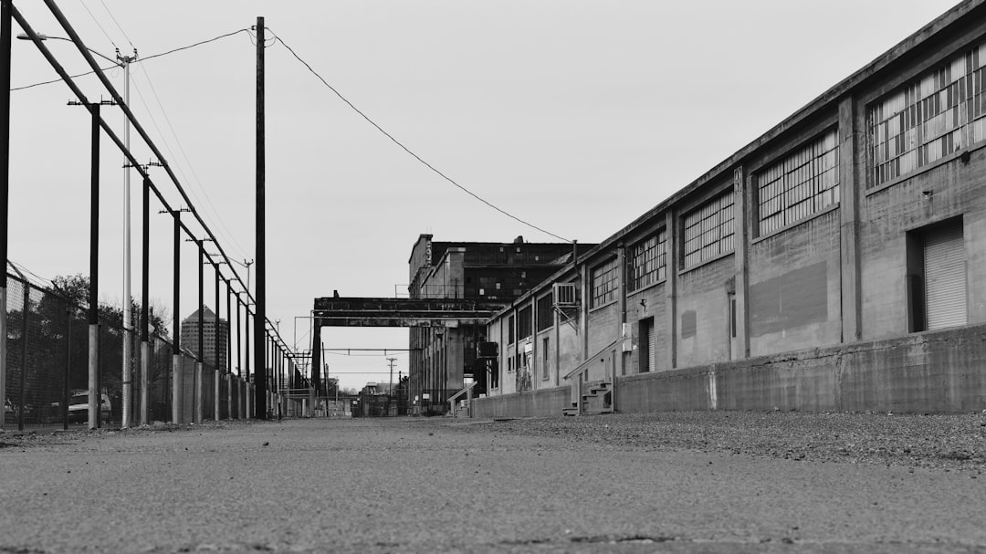 grayscale photo of building near body of water