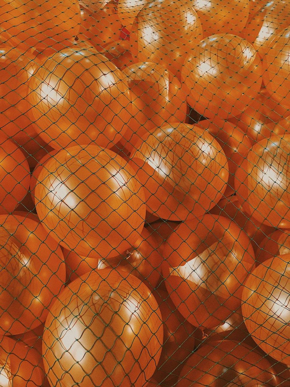 red and gold baubles on brown wooden surface