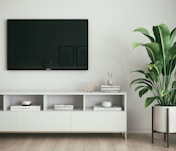 black flat screen tv on white wall