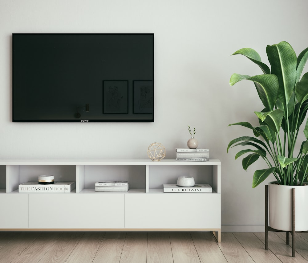 black flat screen tv turned on on white wooden tv hutch photo – Free  Furniture Image on Unsplash