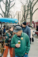 Local candidates engaging warmly with residents at a village market in Glières-Val-de-Borne.
