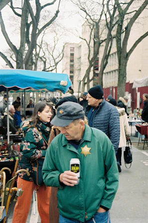 Local candidates engaging warmly with residents at a village market in Glières-Val-de-Borne.