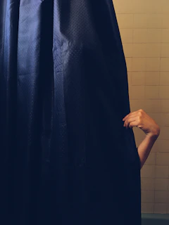 A family stepping out of the shower onto a soft, secure gripaura bath mat.