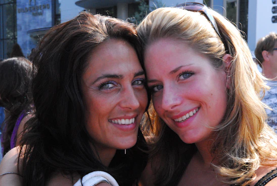 A warm photo of Sabina and Marta smiling together outdoors, radiating friendship and joy.