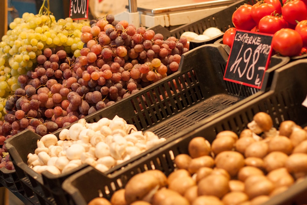 brown round fruits on black plastic crate