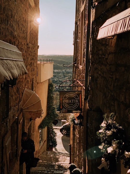 brown concrete building near body of water during daytime in Saint-Paul de Vence France