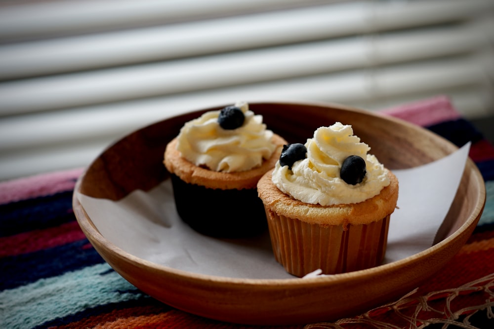 2 cupcakes on white ceramic plate