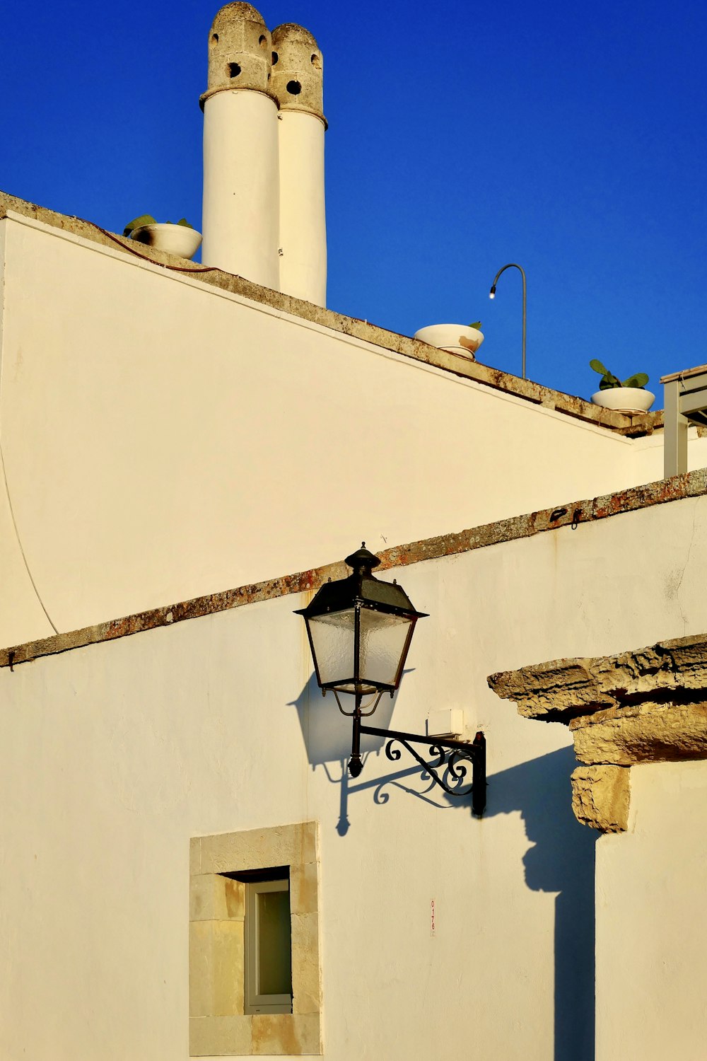 black and white sconce lamp on white wall