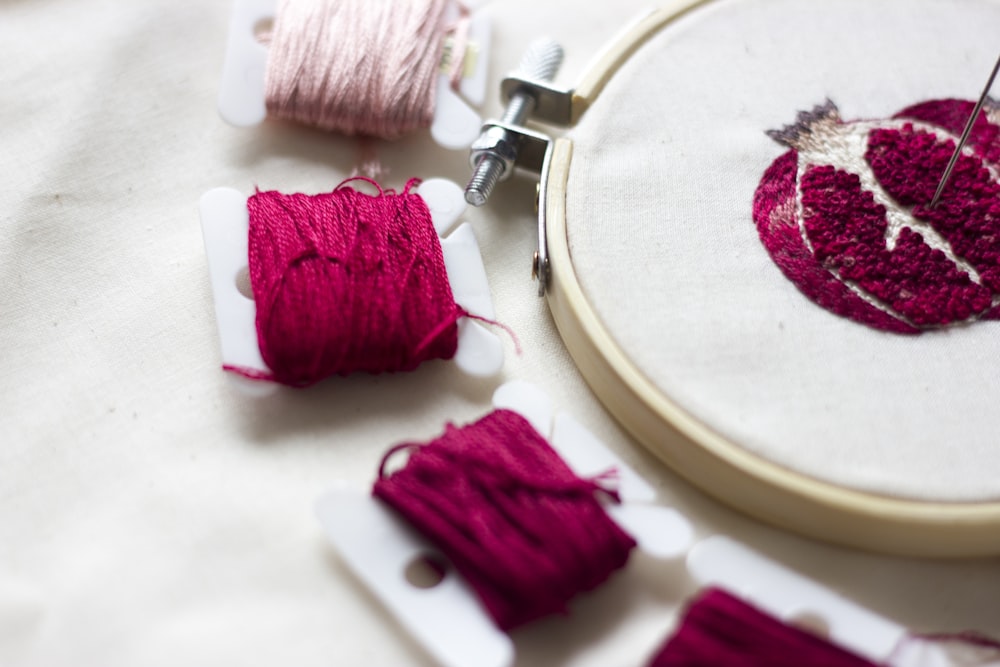 pink thread on white round plate