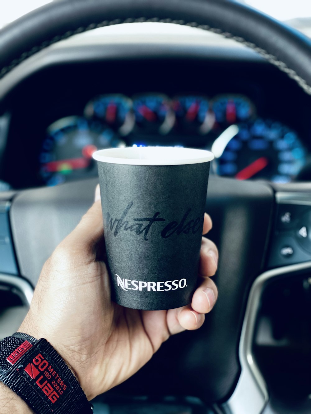 person holding black and white disposable cup