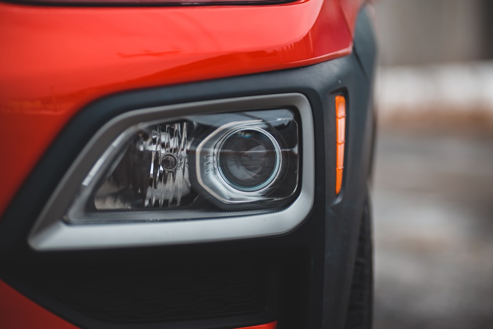 a close up of a red truck's headlight